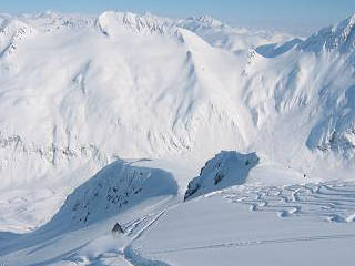 Heli-skiing with Chugach Powder Guides takes place at elevations higher than the lift-served skiing at nearby Alyeska Resort. (skier: Adam Crocker)