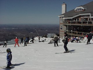 Skiers slide past one small corner of Le Grand Manitou, Tremblant's colossal summit lodge.