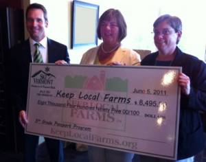 Ski Vermont's Parker Riehle presents a $8,495 contribution to the New England Family Dairy Farms Cooperative Sunday night at Jay Peak Resort. (photo: Ski Vermont) Ski Vermont's Parker Riehle presents a $8,495 contribution to the New England Family Dairy Farms Cooperative Sunday night at Jay Peak Resort. (photo: Ski Vermont)
