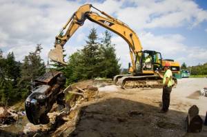 Workers on Friday remove a Killington work vehicle swept away by flood waters from Tropical Storm Irene. (photo: Killington Resort)