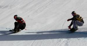 It doesn't get much closer than this: France's Xavier De le Rue crosses the finish line mere inches ahead of American rider Nick Baumgartner to win Saturday's Team SBX competition at the USANA Snowboardcross Cup held in Telluride, Colo. (photo: FIS/Oliver Kraus) It doesn't get much closer than this: France's Xavier De le Rue crosses the finish line mere inches ahead of American rider Nick Baumgartner to win Saturday's Team SBX competition at the USANA Snowboardcross Cup held in Telluride, Colo. (photo: FIS/Oliver Kraus)