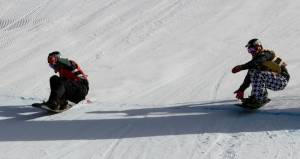 It doesn't get much closer than this: France's Xavier De le Rue crosses the finish line mere inches ahead of American rider Nick Baumgartner to win Saturday's Team SBX competition at the USANA Snowboardcross Cup held in Telluride, Colo. (photo: FIS/Oliver Kraus)