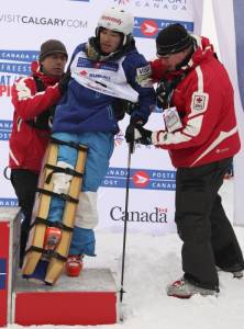 Sho Kashima of South Lake Tahoe, Calif., is helped onto the bronze medal podium by medical staff after injuring his knee in moguls finals at the Canada Post Grand Prix Freestyle Ski World Cup in Calgary on Saturday. (photo: Mike Ridewood/Canadian Freestyle Association)