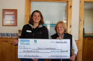 Bertie Holland (R), a representative from Peter’s Fund Racer, receives a $610 check from Lori Rowell, Director of Marketing at Pats Peak, as part of the New Hampshire ski area's  “SPF Days Go Sun Smart” special. (photo: Pats Peak)