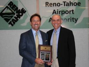 Squaw Valley President and CEO Andy Wirth, left, receives a distinguished service award on Thursday from past Reno-Tahoe Airport Board Chair John Wagnon. (photo: Squaw Valley)