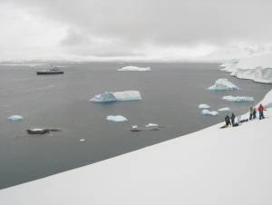 Skiing Wiencke Island, with the Clipper Adventurer in the bay below (photo: FTO/Tony Crocker)