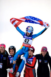 Sarah Hendrickson, of Park City, Utah, is hoisted into the air by her teammates after winning the 2013 FIS Nordic World Ski Championships Women's ski jumping in Val di Fiemme, Italy (photo: Sarah Brunson/U.S. Ski Team)