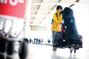 There must be some great pow awaiting, because we don't know anyone who smiles like this while lugging their skis and bags through an airport! (file photo: Dakine)