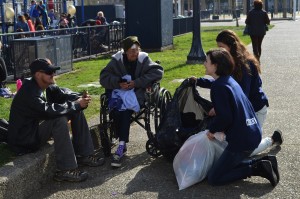 Corinne Hindes, of Walnut Creek, Calif., distributes items from ski resorts' lost and found bins to the homeless. (photo: Barron Prize)