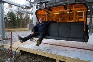 Author Martin Griff was not going to let unseasonably warm East Coast weather spoil the debut of the Quantum Four orange-tinted bubble high-speed chair lift at Okemo Mountain Resort in central Vermont on December 12. But without lift operators it wasn’t much of a ride. (photo: Iseult Devlin)