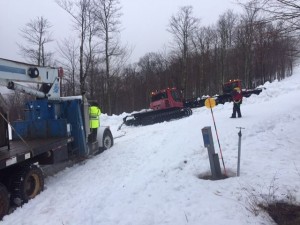 Workers use two snowcats to pull a stuck boom truck into place. (photo: Timberline Four Seasons Resort)