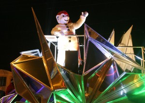 Bonhomme, the loveable mascot of the Québec City Winter Carnival rides in the last float during the 2015 nighttime parade in Charlesbourg. (Photo: FTO/Martin Griff)