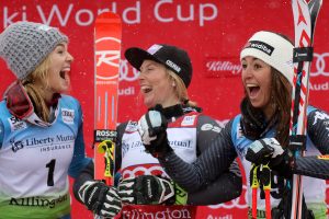 Nina Loeseth (NOR) in second place, Tessa Worley (FRA) in first place and Sofia Goggia (ITA) third place share a laugh on the podium at the conclusion of the Audi FIS Ski World Cup Giant Slalom at Killington in central Vermont. (FTO photo: Martin Griff)