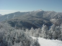 From Madonna Mountain, Mt. Mansfield and Stowe's ski trails dominate the southern horizon, with Sterling Mt. in the middle ground (photo Marc Guido)