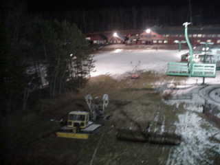 Snowcats lined up, parked with snow guns in tow (photo Marc Guido)