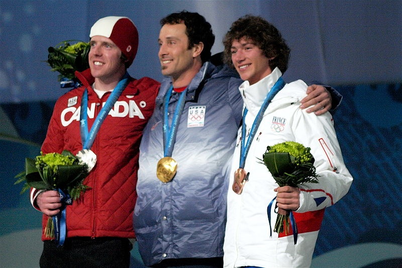 Canada's Mike Robertson, left, stands on the snowboardcross podium at the 2010 Olympic Winter Games with American rider Seth Wescott and Tony Ramoin of France.