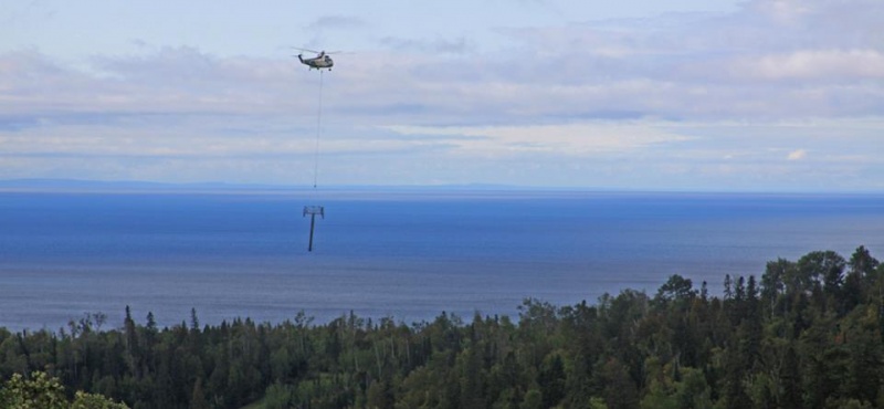 A helicopter flies towers into place on Friday for Lutsen's new six-seat Caribou Express chairlift. (photo: Lutsen Mountains)