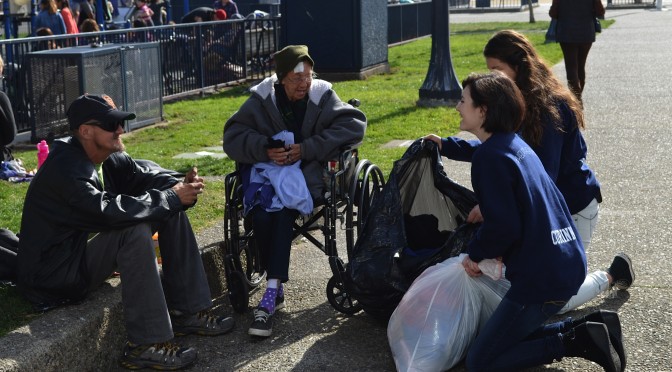 Corinne Hindes, of Walnut Creek, Calif., distributes items from ski resorts' lost and found bins to the homeless. (photo: Barron Prize)